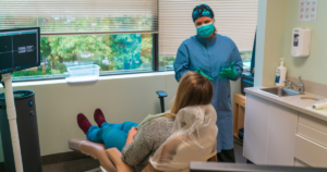 Dental Hygienist explaining something to patient in dental practice in Albany, NY